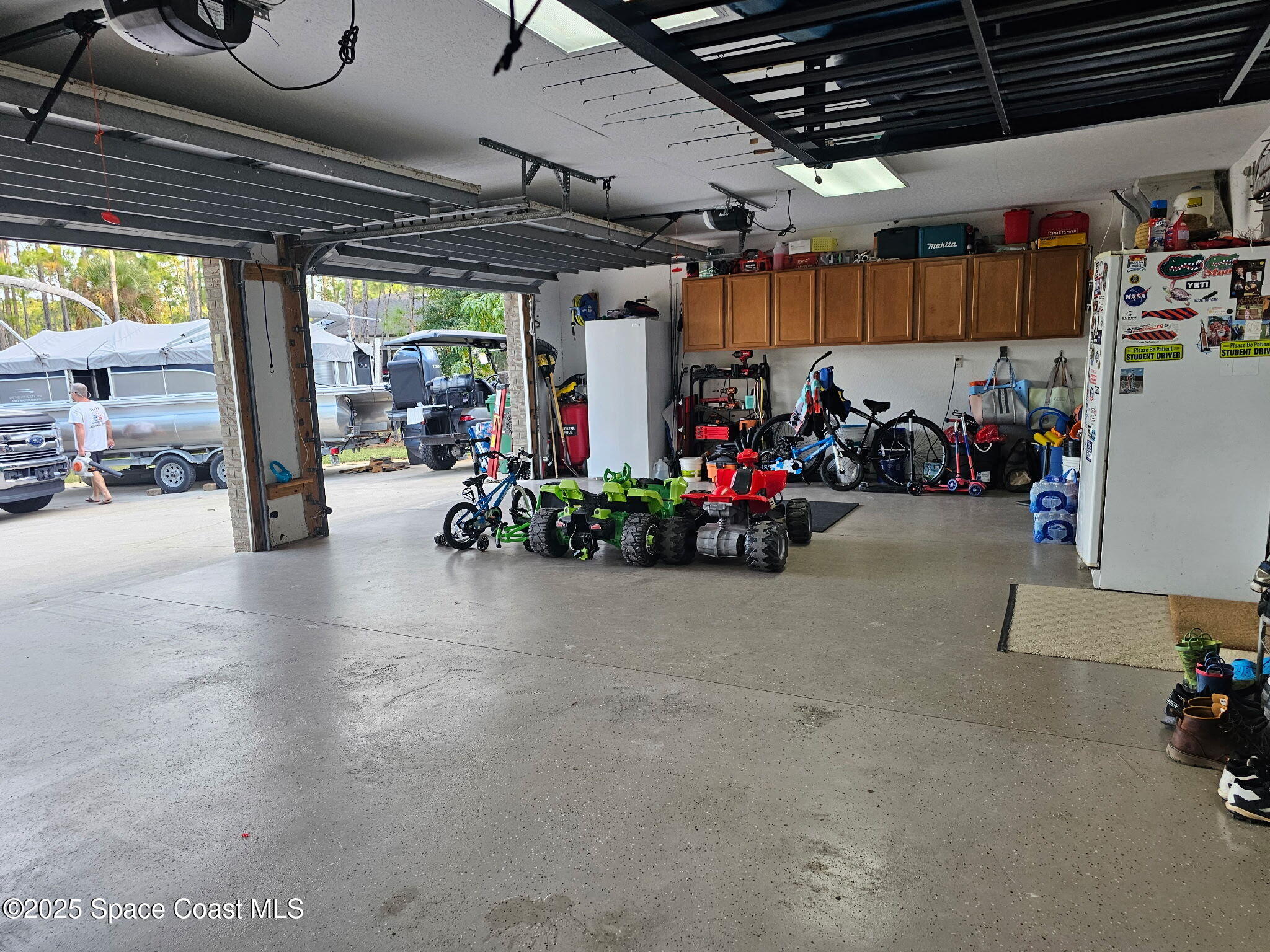 3094 Green Turtle Circle Mims, FL 32754 - Photo 58 of 63 a view of a garage with a bike and car