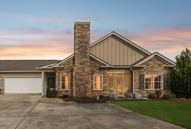 a kitchen with stainless steel appliances a sink a stove and white cabinets
