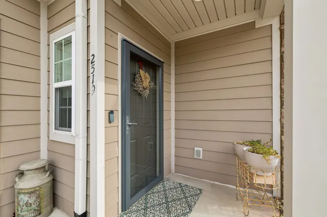 a living room with furniture fireplace and a large window