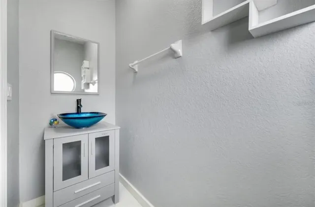 a bathroom with a sink a mirror and a lamp