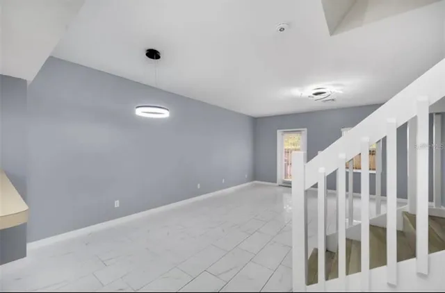 a view of an empty room with stairs