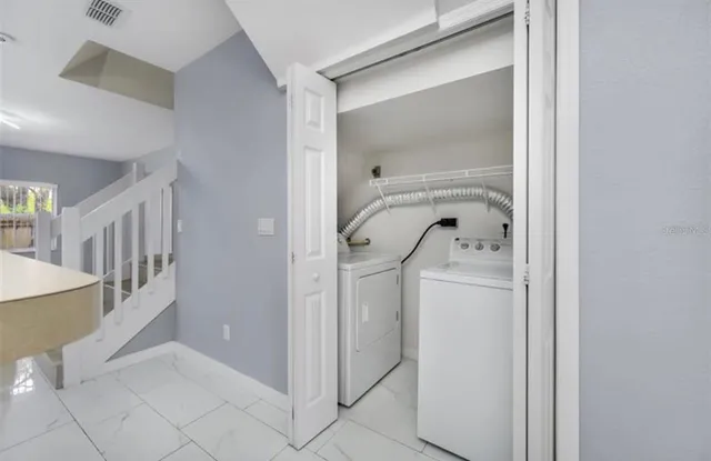a view of an entryway with a washer and dryer