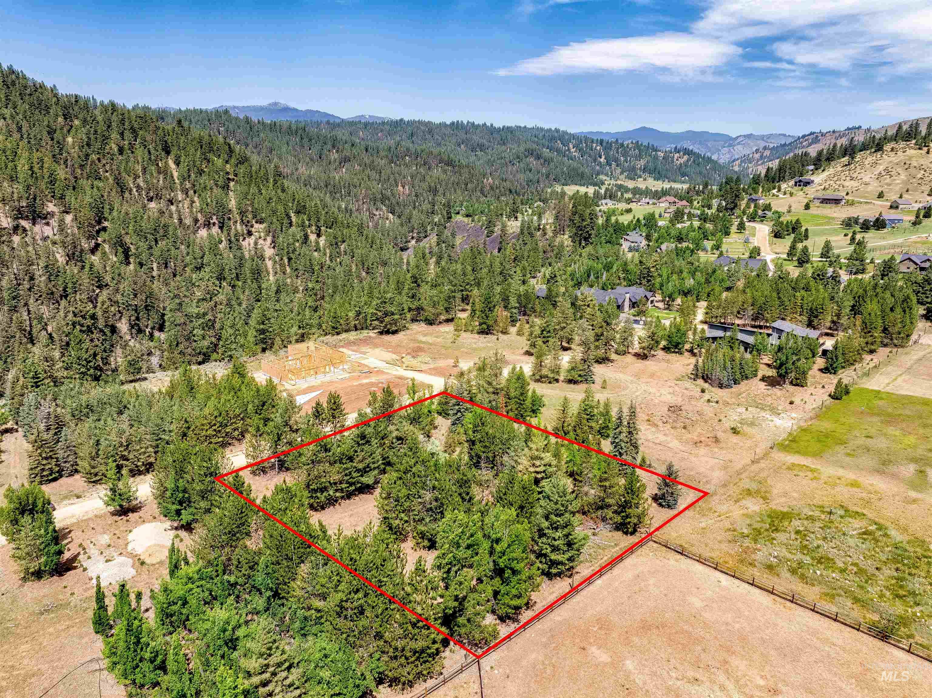 Aerial view of property's location with mountains and property parcel outlined