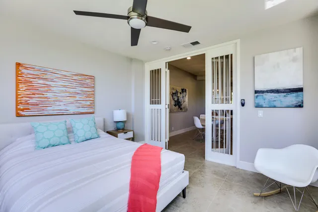 a bedroom with a bed and a chair