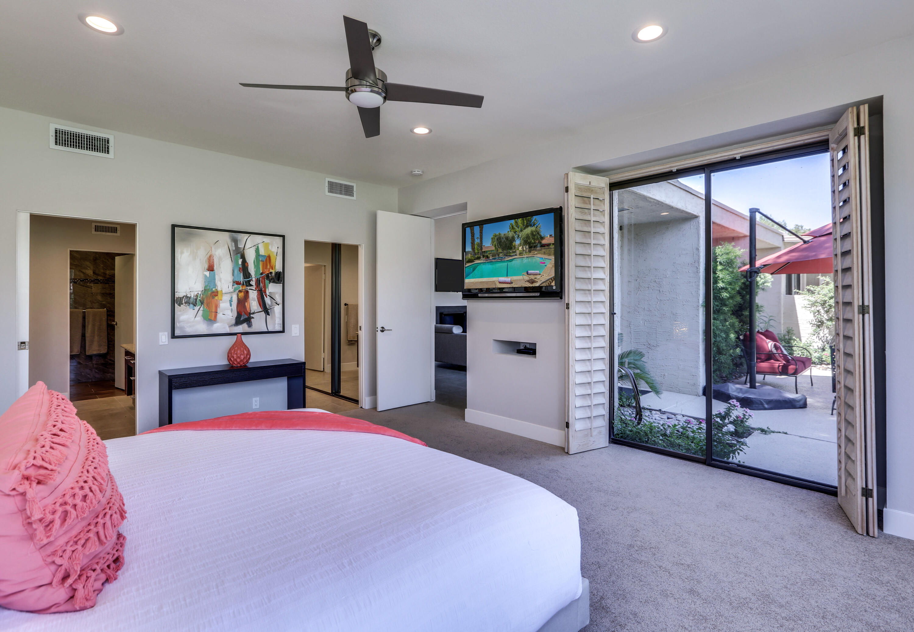136 Desert W Drive Rancho Mirage, CA 92270 - Photo 29 of 46 a bedroom with a bed and dresser with mirror