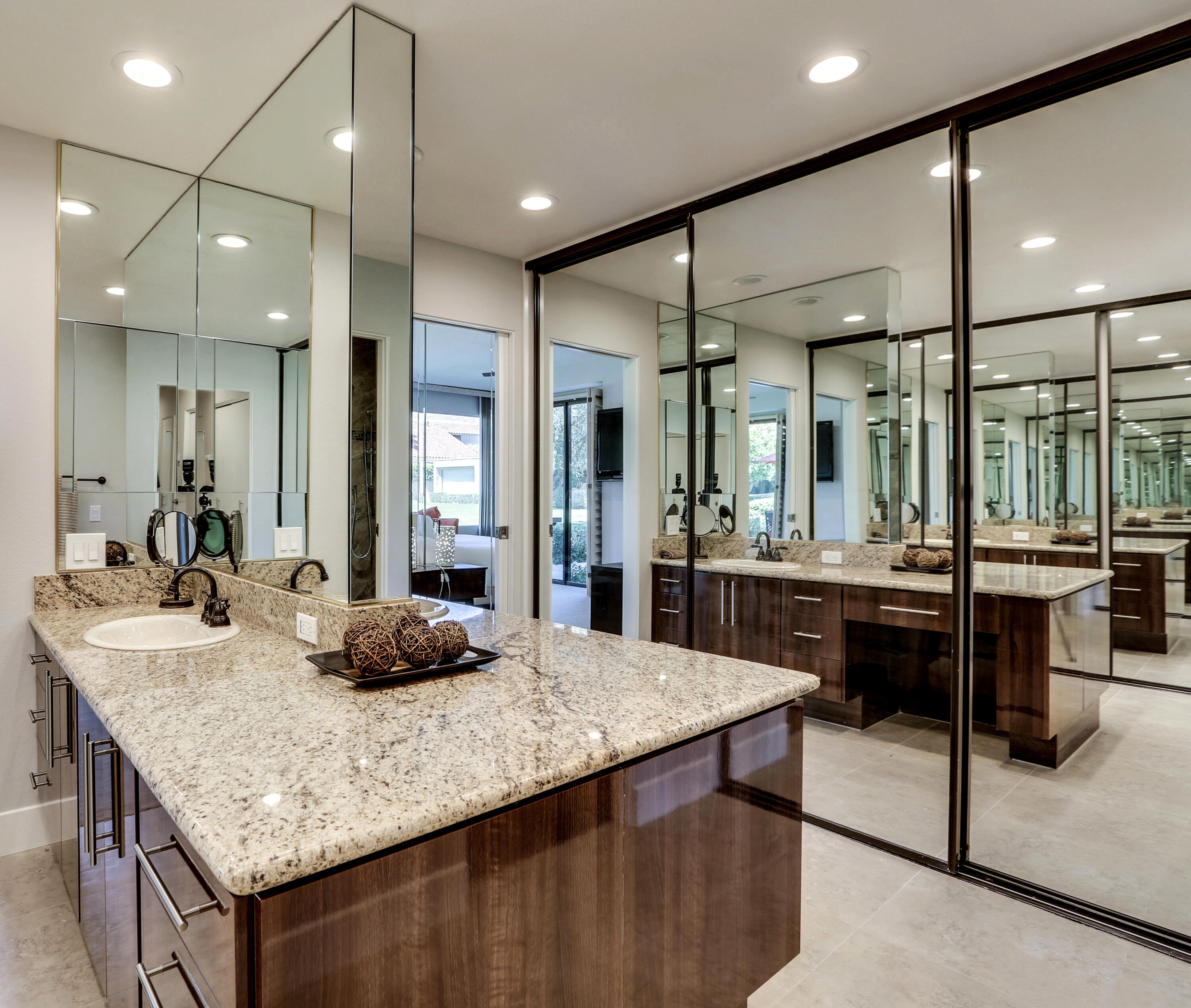 136 Desert W Drive Rancho Mirage, CA 92270 - Photo 30 of 46 a kitchen with kitchen island granite countertop a table and chairs in it