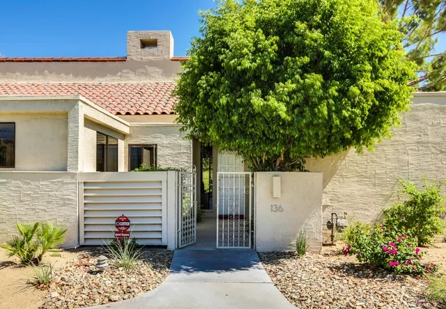 a front view of a house with a garden