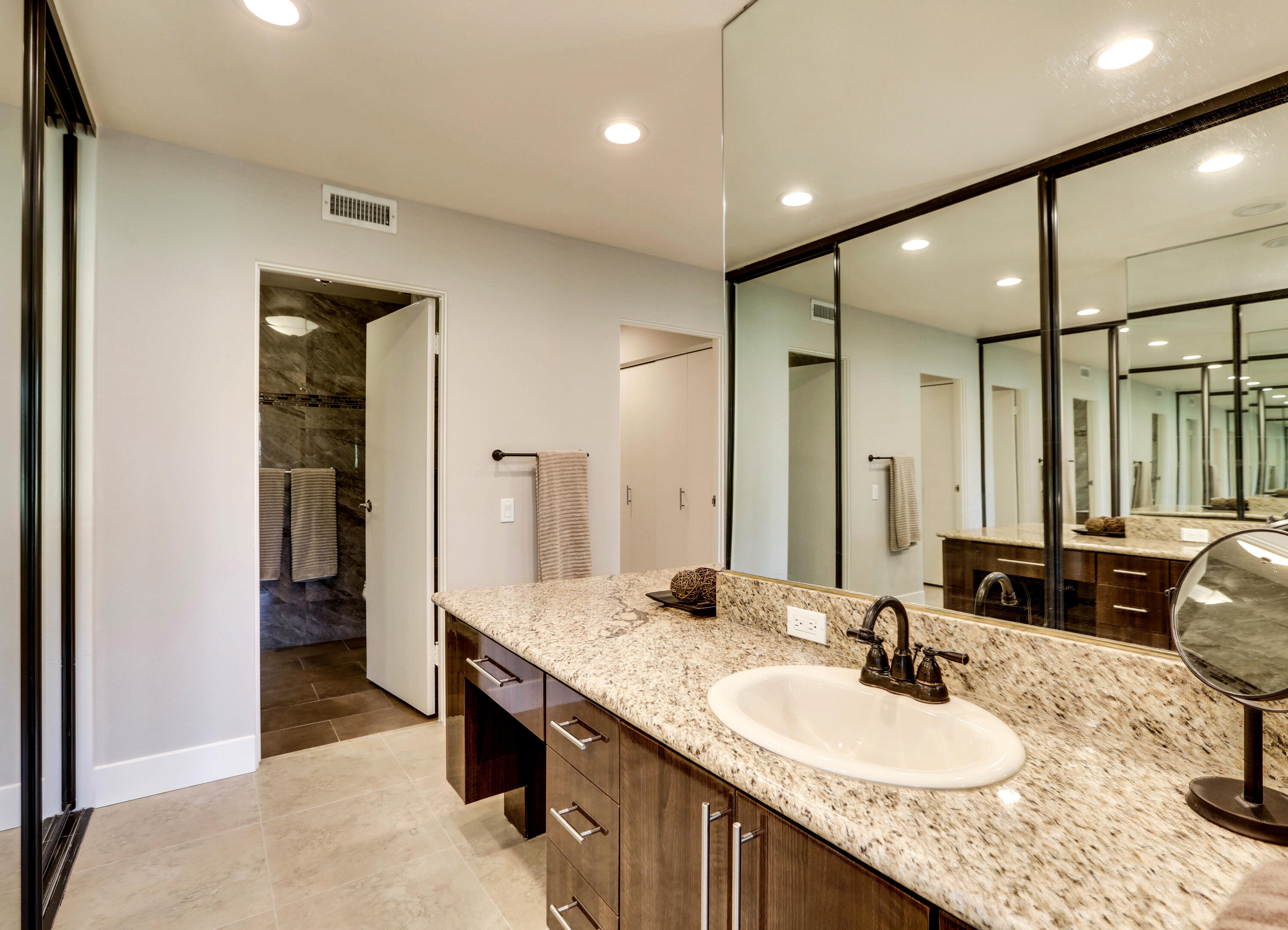 136 Desert W Drive Rancho Mirage, CA 92270 - Photo 31 of 46 a bathroom with a double vanity sink and a mirror