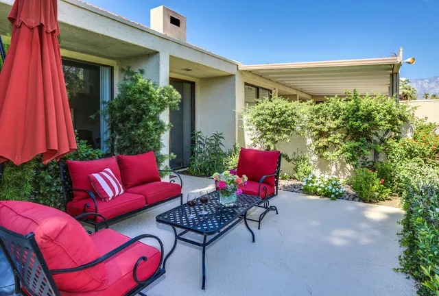 a backyard of a house with lots of green space and fountain
