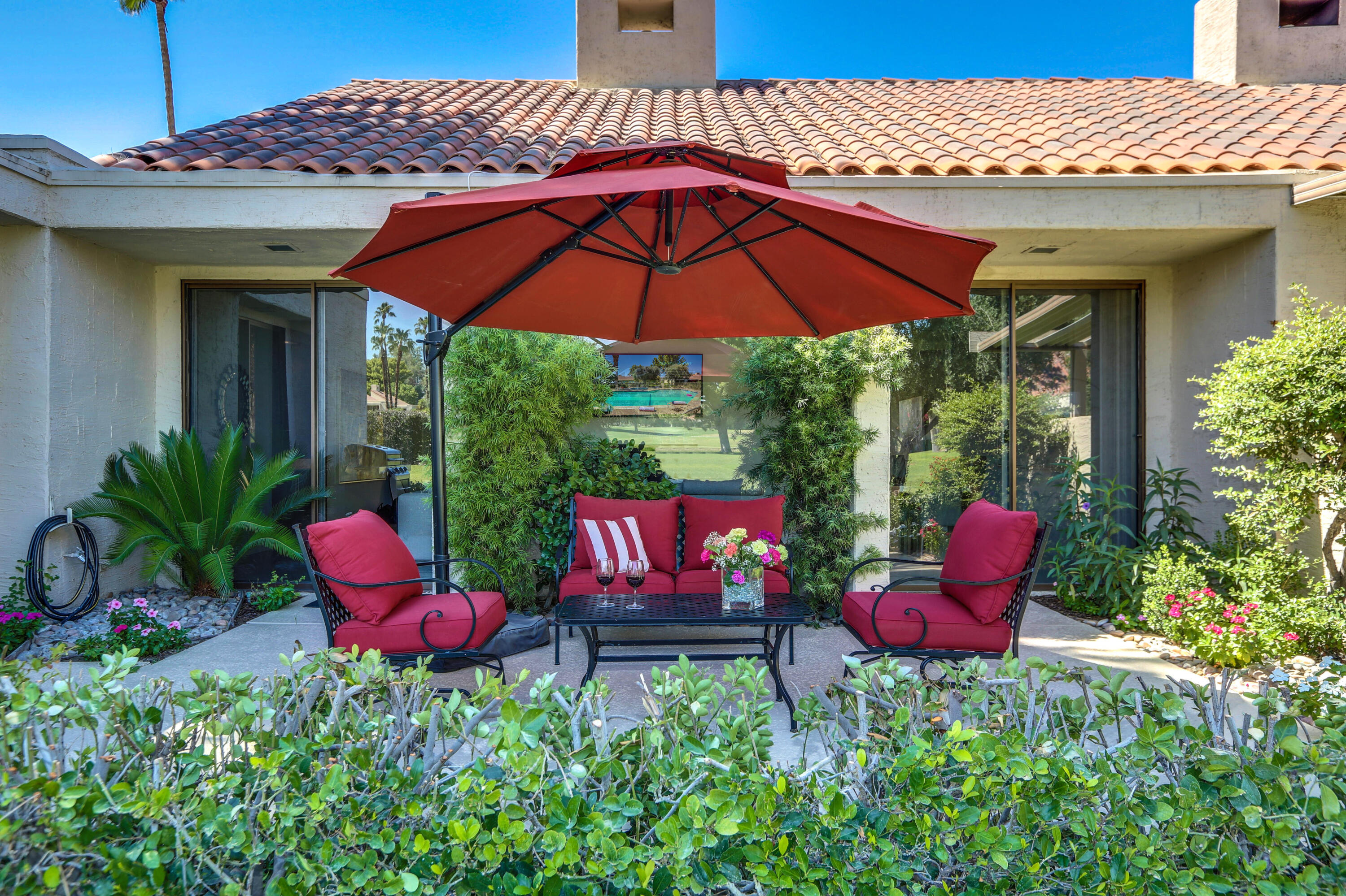 136 Desert W Drive Rancho Mirage, CA 92270 - Photo 41 of 46 a view of an chairs and table in the patio
