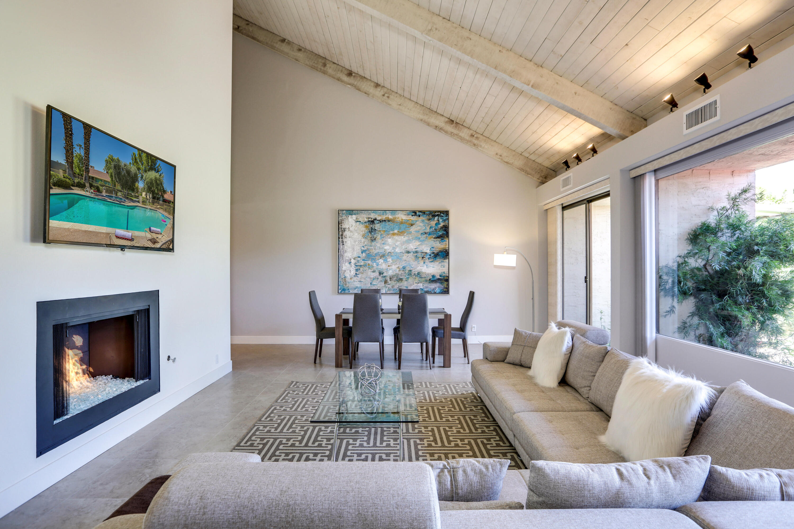 136 Desert W Drive Rancho Mirage, CA 92270 - Photo 8 of 46 a living room with furniture a fireplace and a large window