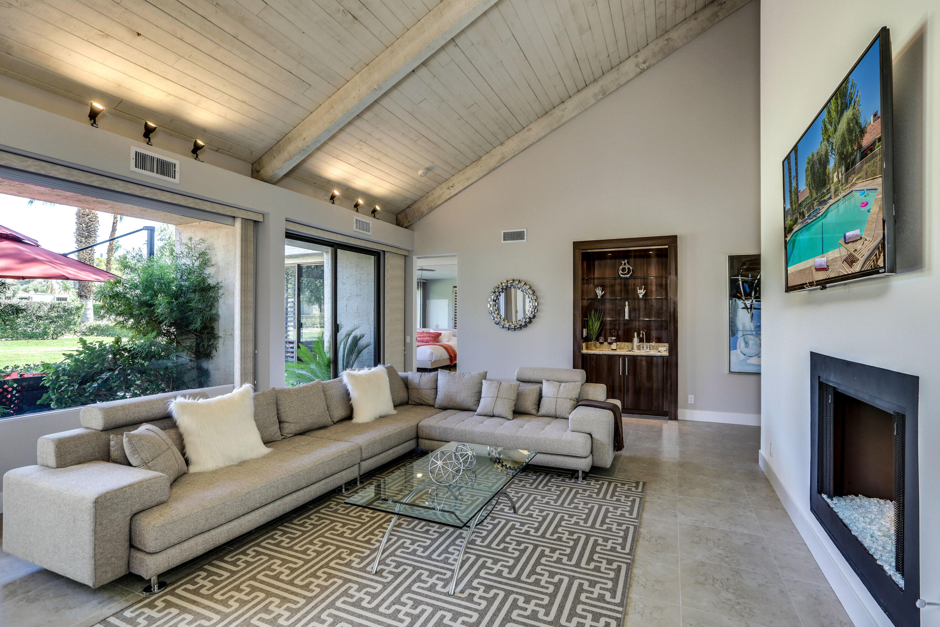 136 Desert W Drive Rancho Mirage, CA 92270 - Photo 10 of 46 a living room with furniture a fireplace and a flat screen tv