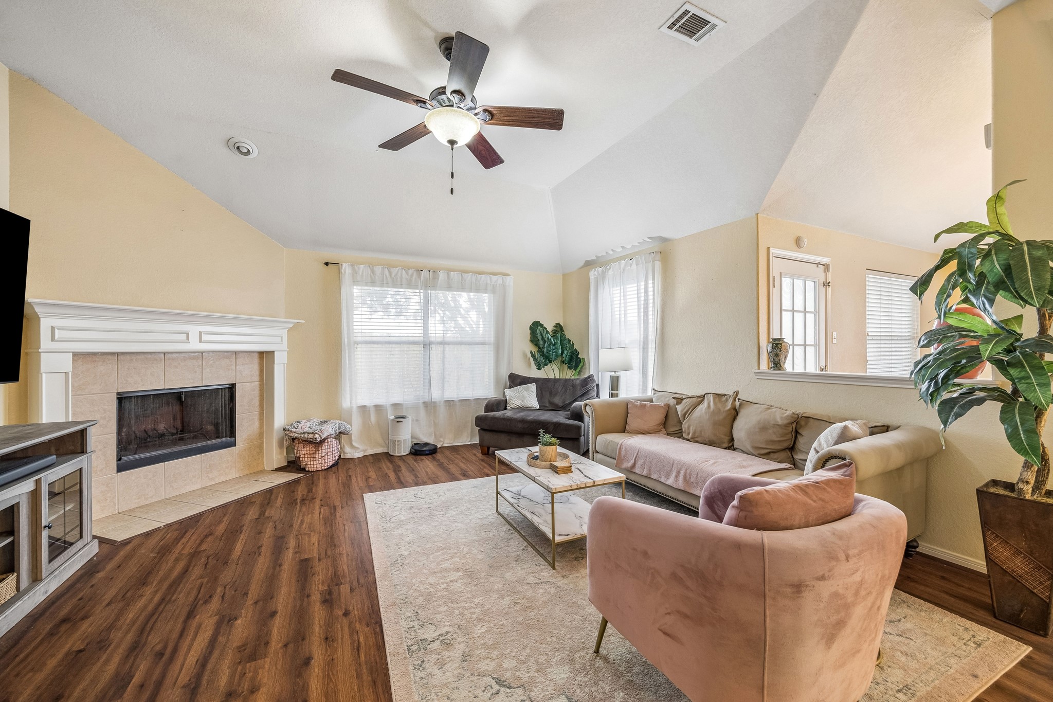 24027 Floragate Drive Spring, TX 77373 - Photo 5 of 21 a living room with furniture a fireplace and a flat screen tv