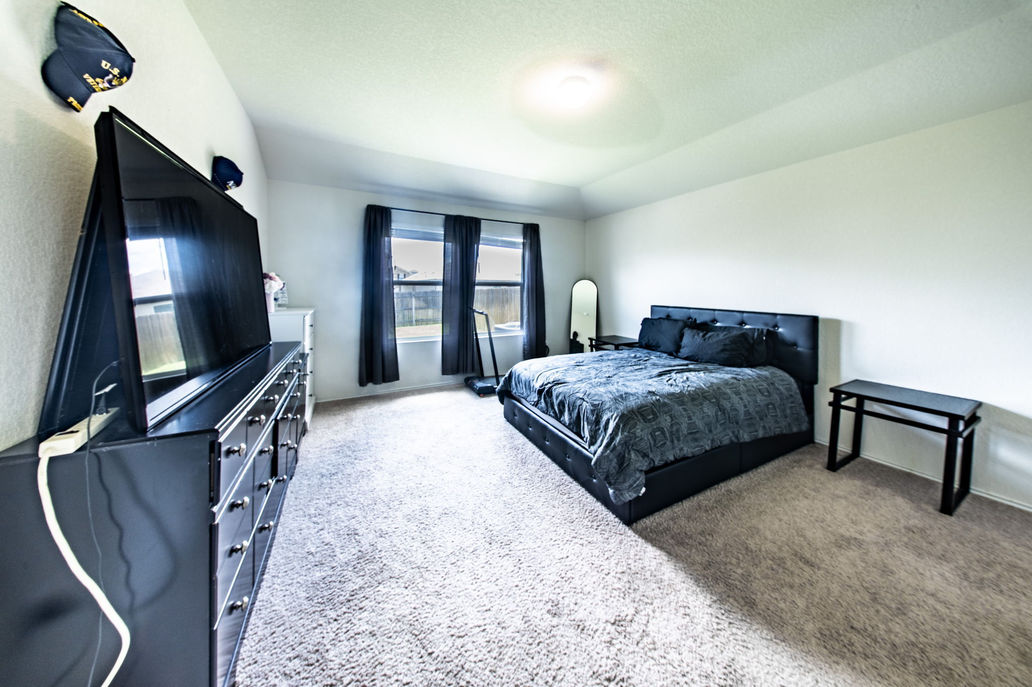 14903 Tuff Road Manor, TX 78653 - Photo 7 of 25 Well-lit room featuring ample space for furnishings and soft, neutral carpeting.