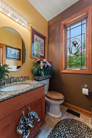 a bathroom with a toilet a sink and a mirror