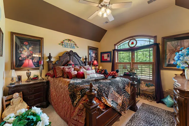 a bed room with a bed mirror and a window