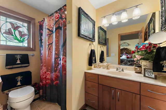 a bathroom with a sink mirror and toilet