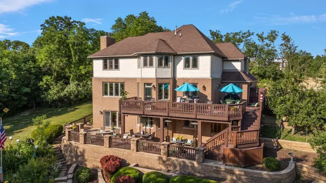 a front view of a house with garden water fountain and a fire pit