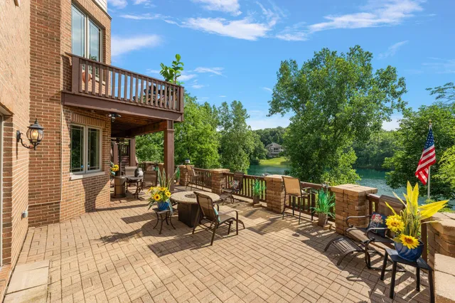 a view of a patio with table and chairs and wooden floor