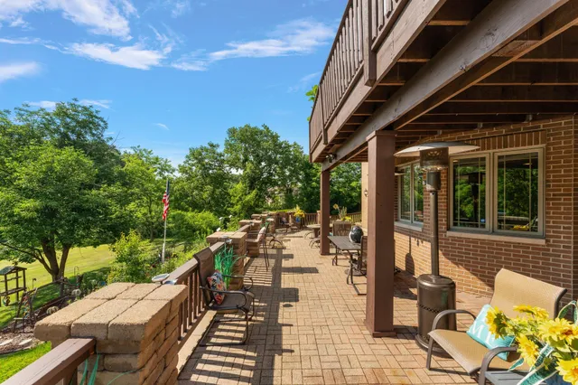 a view of a patio with couches table and chairs and potted plants