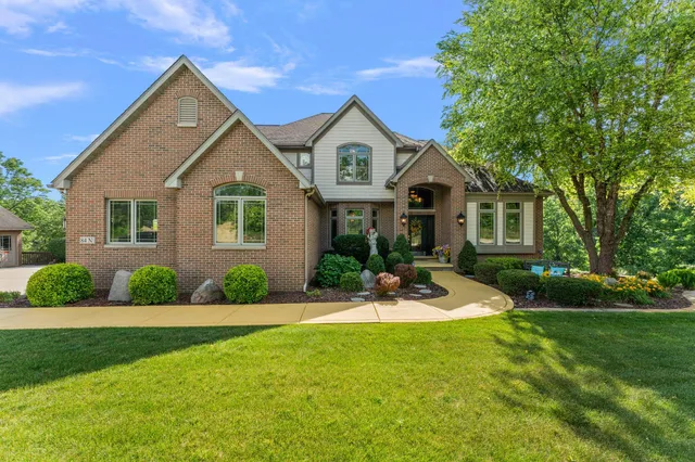 a front view of house with yard and green space