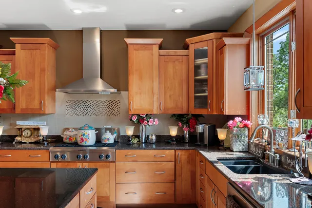 a kitchen with stainless steel appliances a sink a stove and a refrigerator