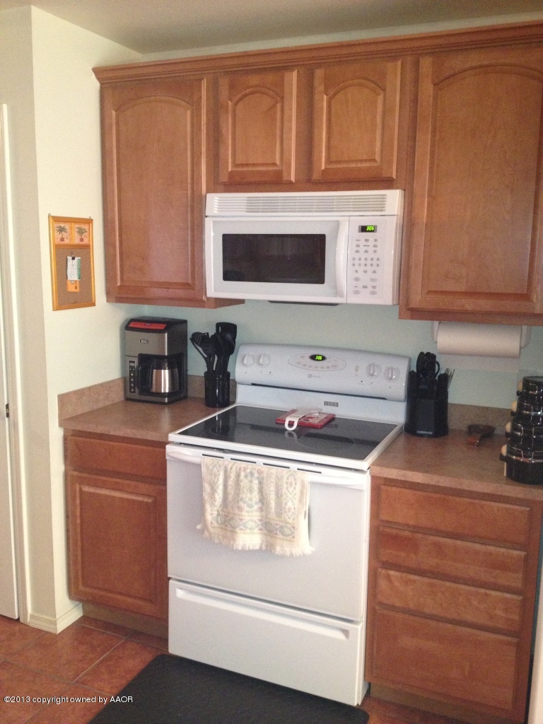 4801 Nimbus Lane Amarillo, TX 79110 - Photo 11 of 40 a kitchen with granite countertop cabinets stainless steel appliances and a sink
