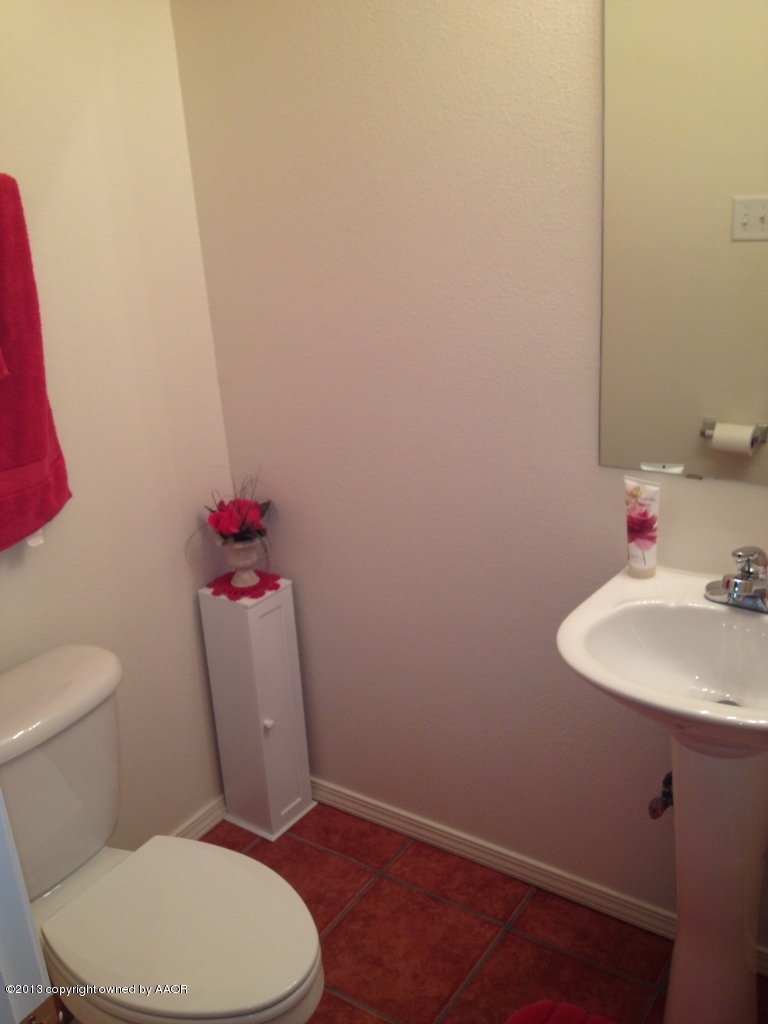 4801 Nimbus Lane Amarillo, TX 79110 - Photo 18 of 40 a bathroom with a sink and a toilet