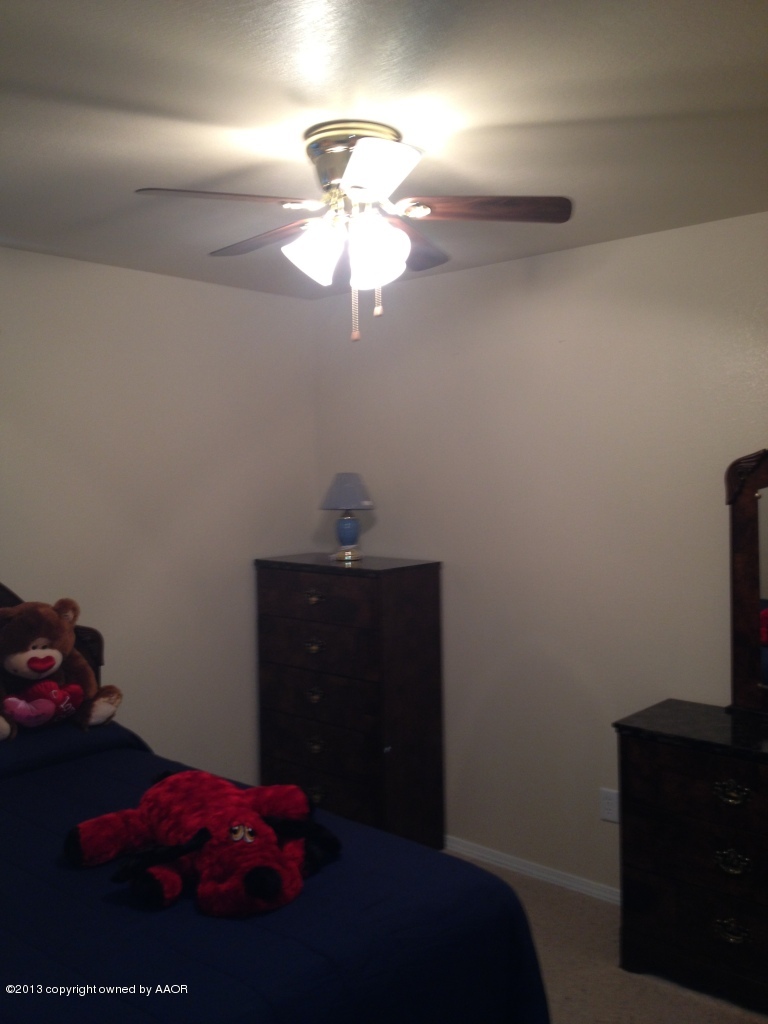 4801 Nimbus Lane Amarillo, TX 79110 - Photo 22 of 40 a bedroom with a bed and a chandelier fan