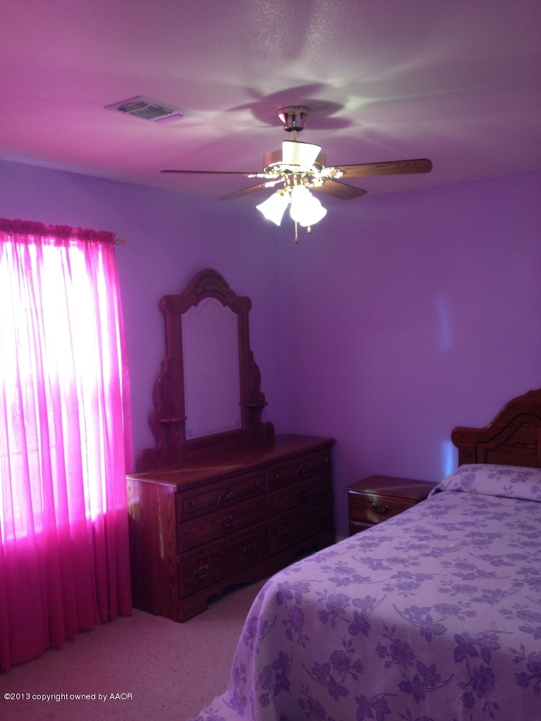 4801 Nimbus Lane Amarillo, TX 79110 - Photo 27 of 40 a bedroom with a bed chandelier and a window