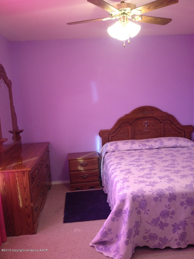 4801 Nimbus Lane Amarillo, TX 79110 - Photo 28 of 40 a bedroom with a bed and a chandelier
