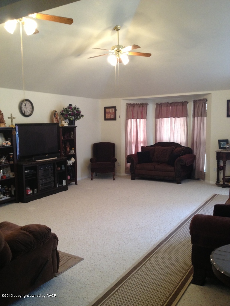 4801 Nimbus Lane Amarillo, TX 79110 - Photo 6 of 40 a living room with furniture a flat screen tv and a dresser