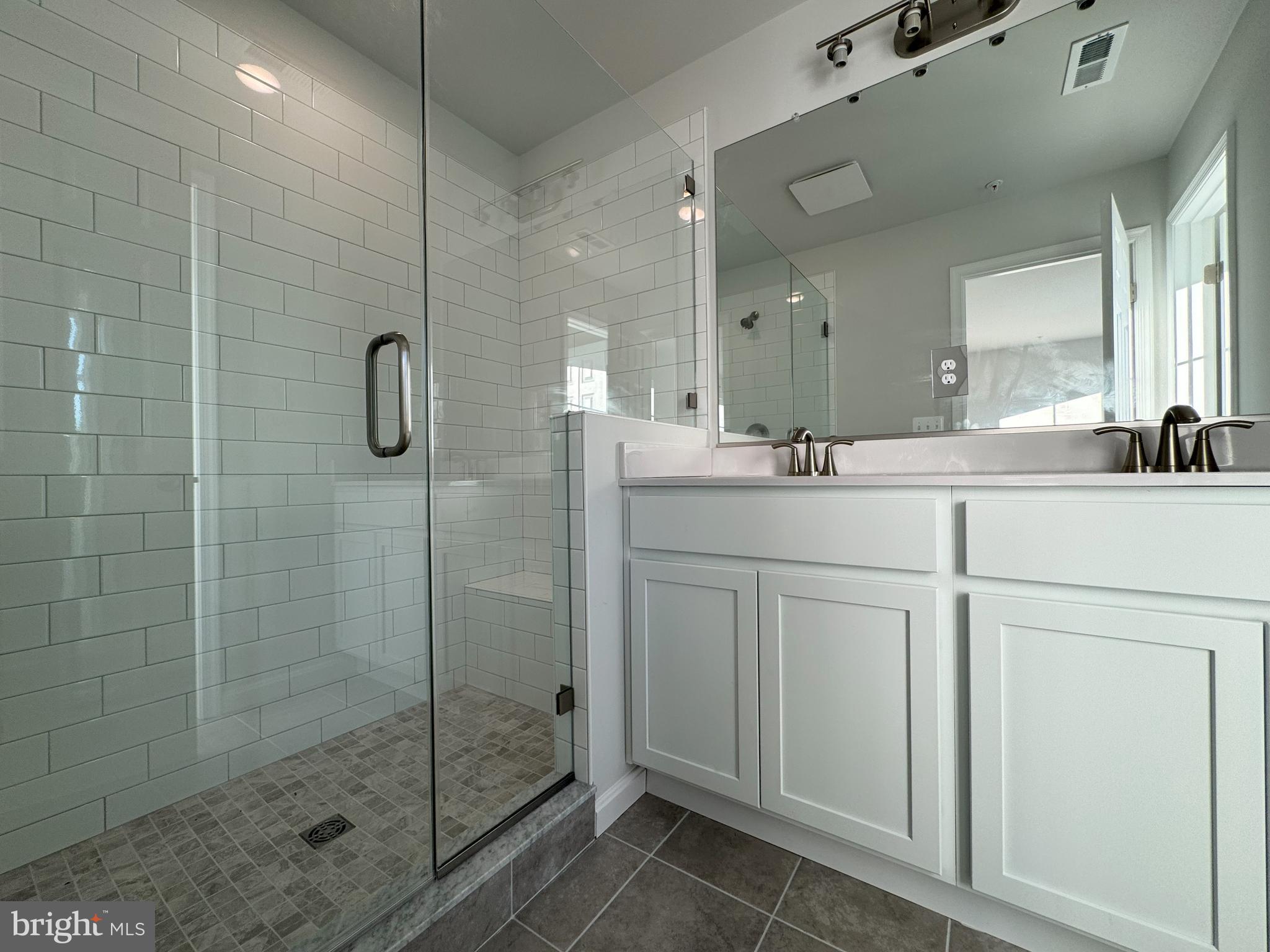 11306 H G Trueman Road Lusby, MD 20657 - Photo 15 of 33 a bathroom with a shower sink and mirror