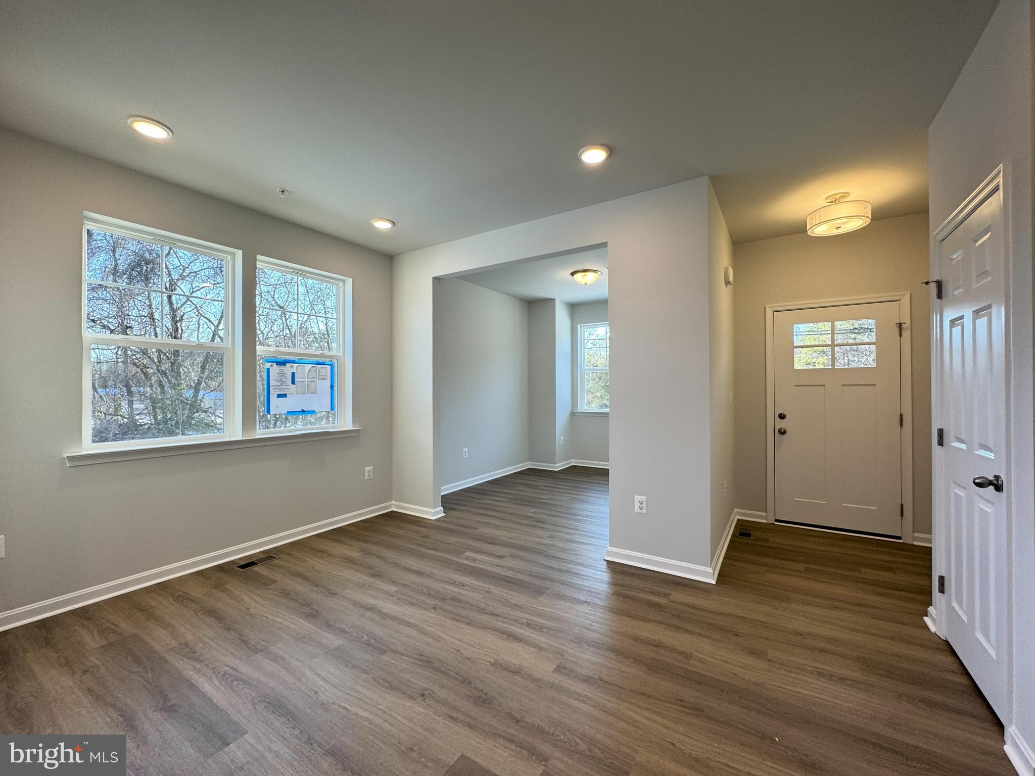 11306 H G Trueman Road Lusby, MD 20657 - Photo 2 of 33 a view of an empty room with wooden floor and a window