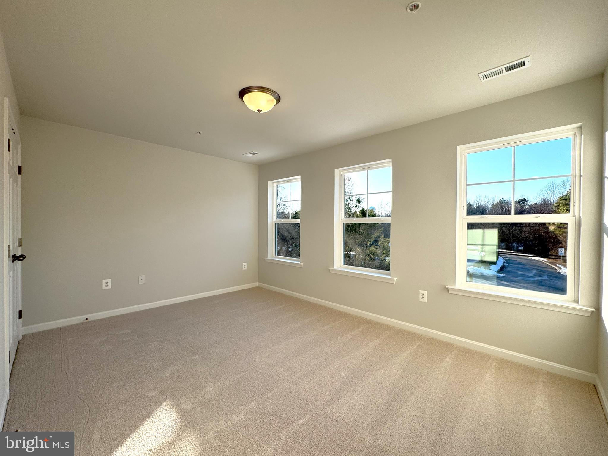11306 H G Trueman Road Lusby, MD 20657 - Photo 21 of 33 an empty room with large windows