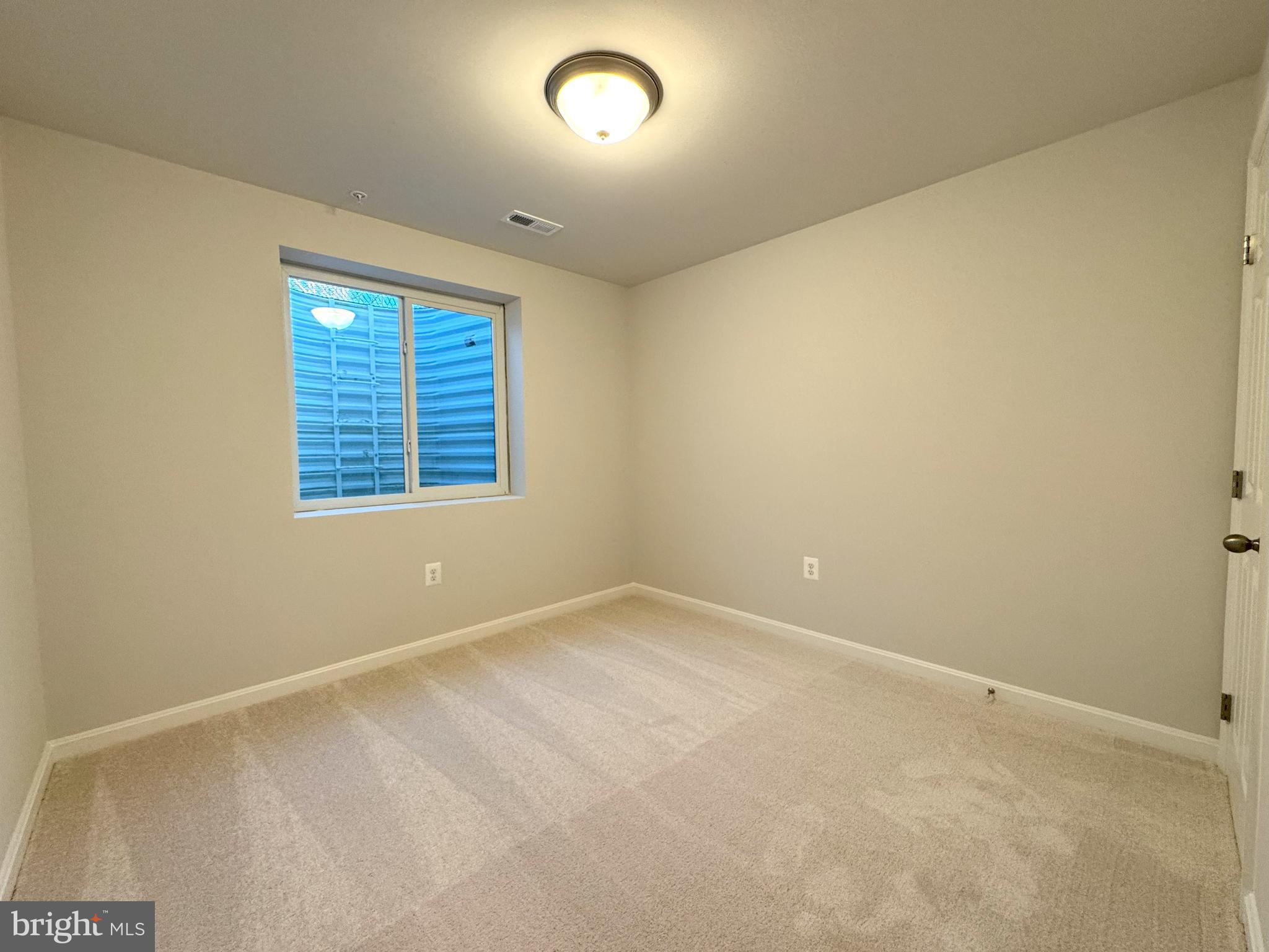11306 H G Trueman Road Lusby, MD 20657 - Photo 24 of 33 an empty room with a empty space and windows