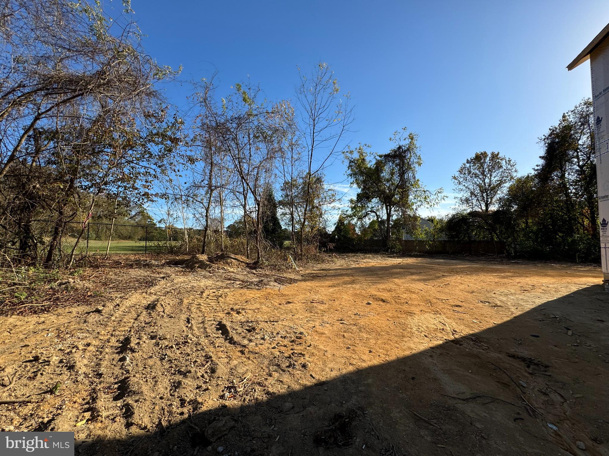 11306 H G Trueman Road Lusby, MD 20657 - Photo 30 of 33 a view of a yard with wooden fence