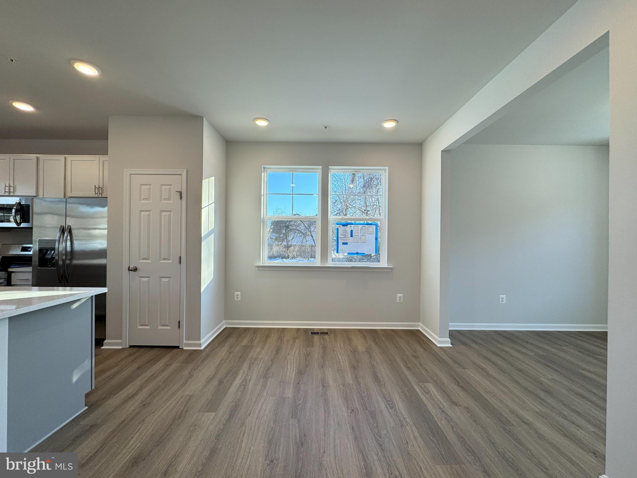 11306 H G Trueman Road Lusby, MD 20657 - Photo 4 of 33 an empty room with wooden floor and windows