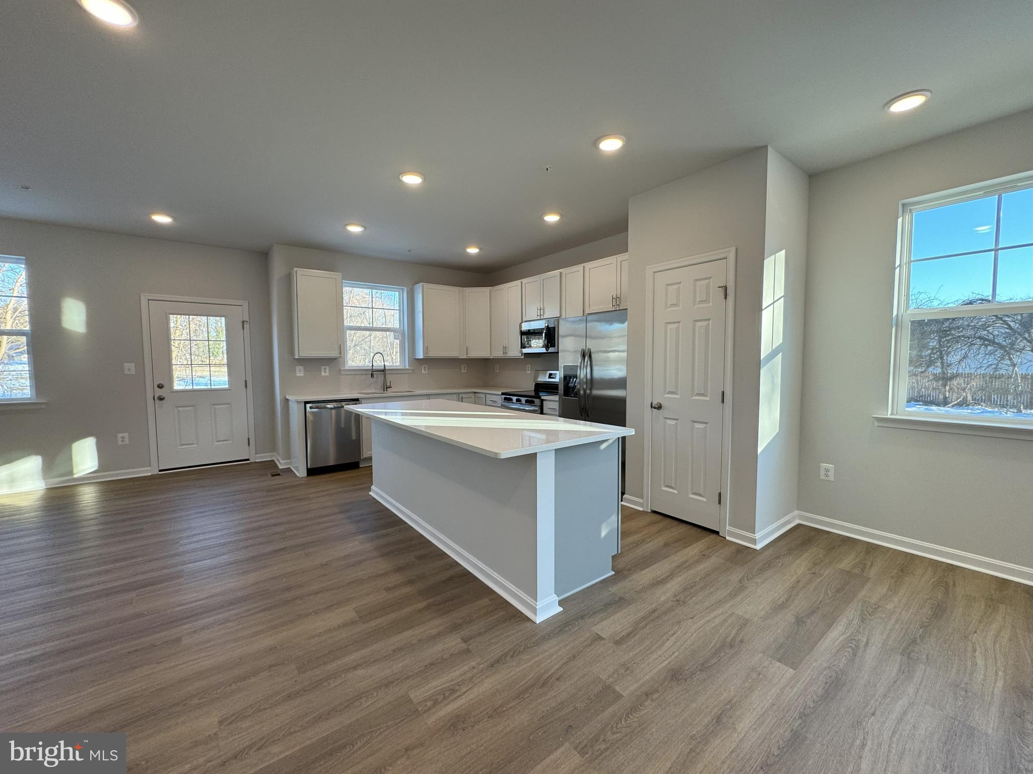 11306 H G Trueman Road Lusby, MD 20657 - Photo 5 of 33 a large kitchen with stainless steel appliances granite countertop a stove a sink and a refrigerator