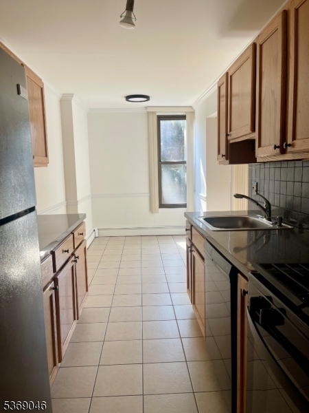 21 River Road, Unit G Nutley, NJ 07110 - Photo 11 of 22 a kitchen with a sink a stove and a microwave