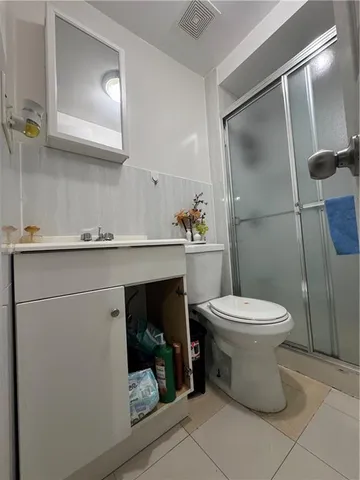 a view of a house with a patio and a yard