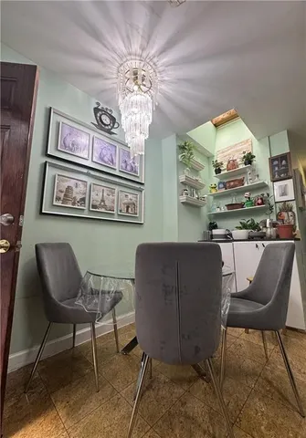 a dining room filled with furniture and chandelier