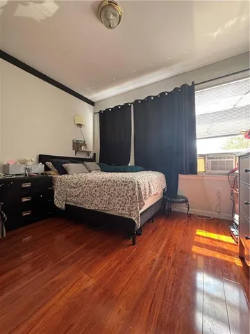 a bedroom with double bed and a couch