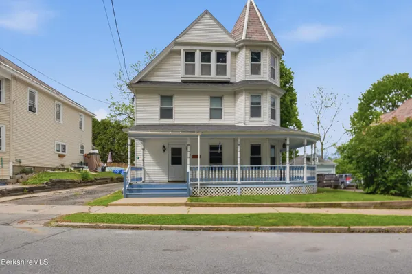 a front view of a house with a swimming pool
