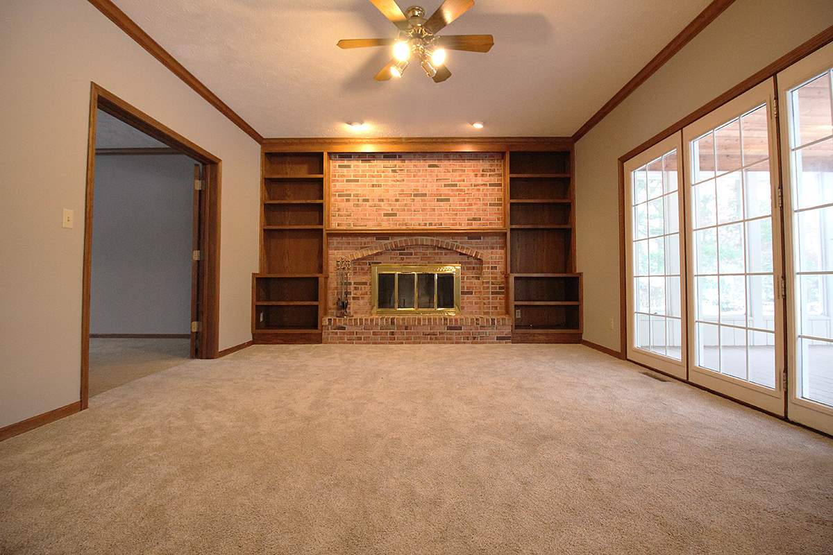 7097 Sentinel Road Rockford, IL 61107 - Photo 3 of 25 an empty room with fireplace fan and windows