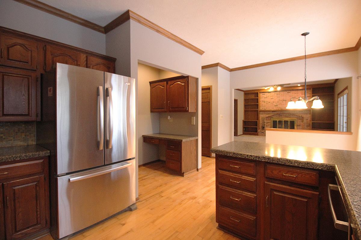 7097 Sentinel Road Rockford, IL 61107 - Photo 8 of 25 a kitchen with a refrigerator and microwave