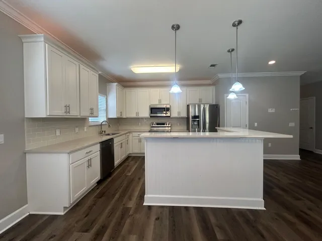 a large kitchen with stainless steel appliances kitchen island a large island in the center