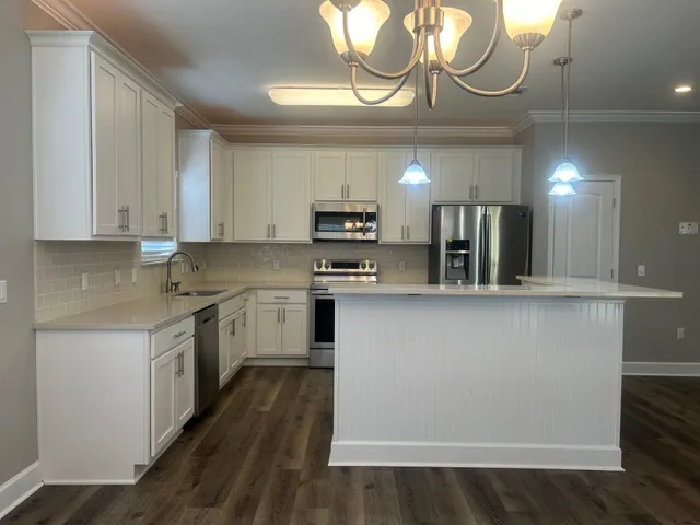 a kitchen with cabinets a sink and a stove