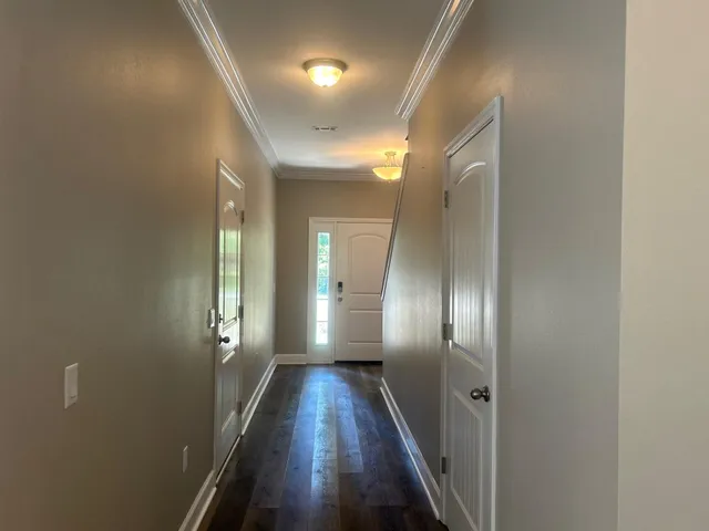 a view of a hallway with wooden floor