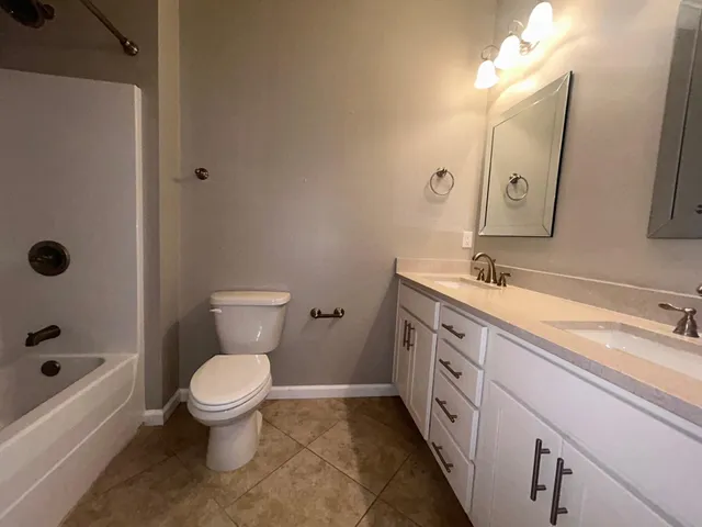 a bathroom with a double vanity sink and mirror